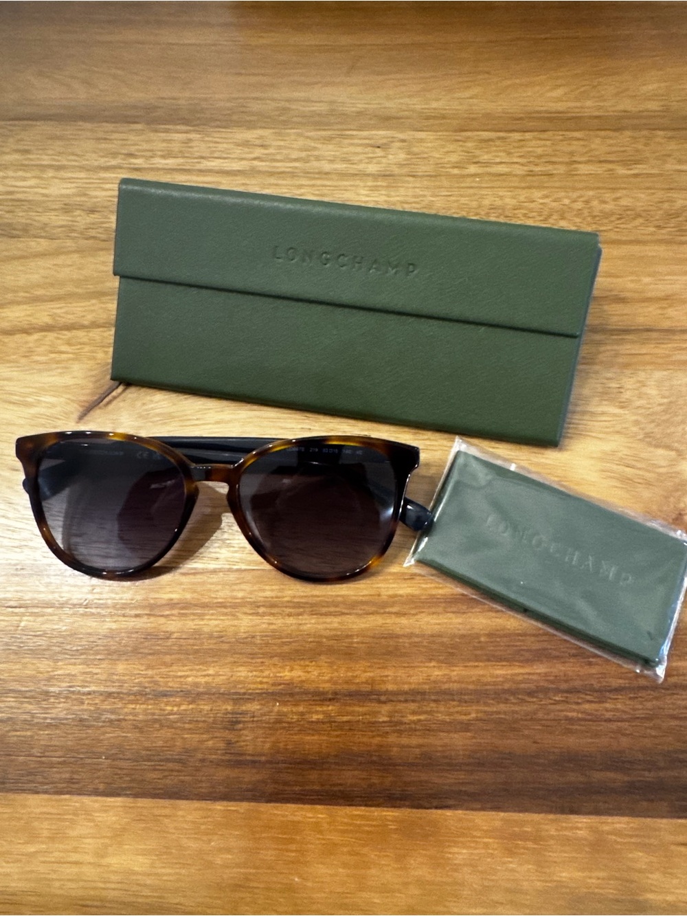 Sunglasses with case on wooden table